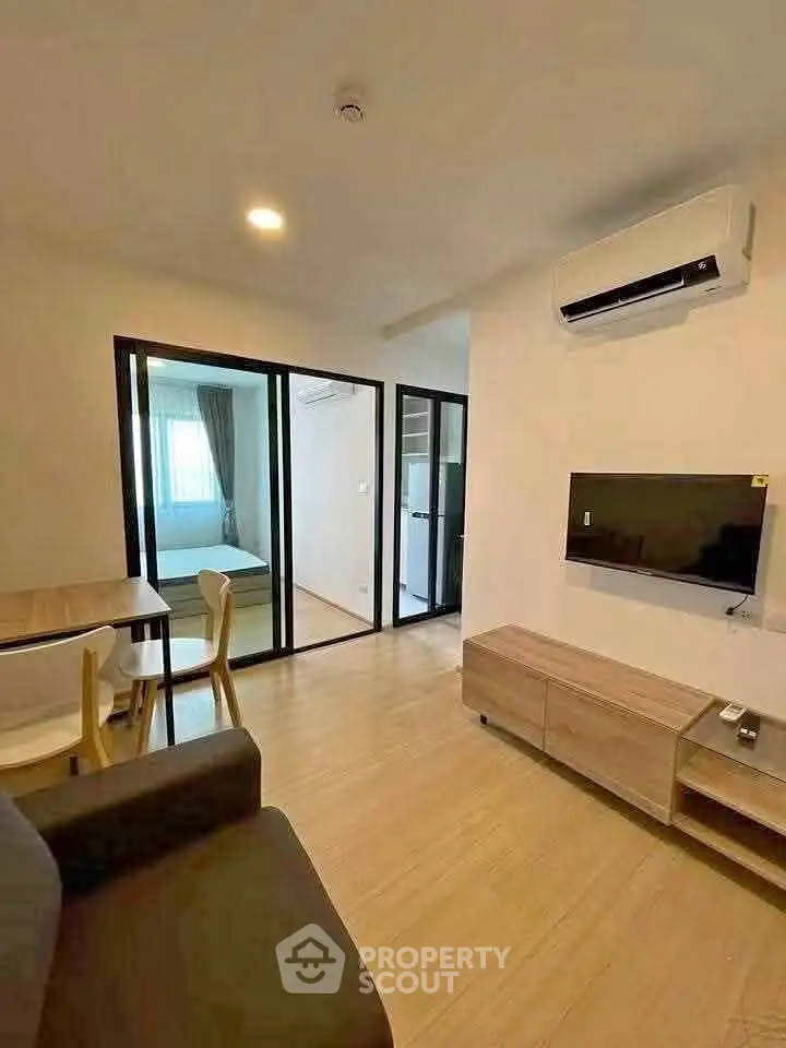 Modern living room with sleek furniture and air conditioning in a cozy apartment.