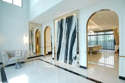 Luxurious open-plan living area with elegant marble accents and spacious dining room.