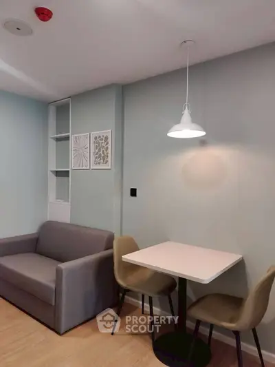 Cozy modern living room with sofa and dining area, perfect for urban living.