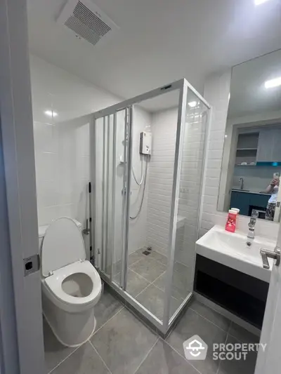 Modern bathroom with glass shower enclosure and sleek fixtures