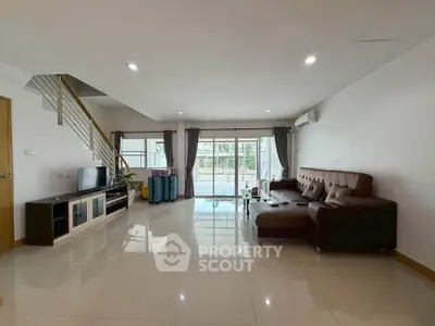 Spacious modern living room with sleek design and large windows for natural light.