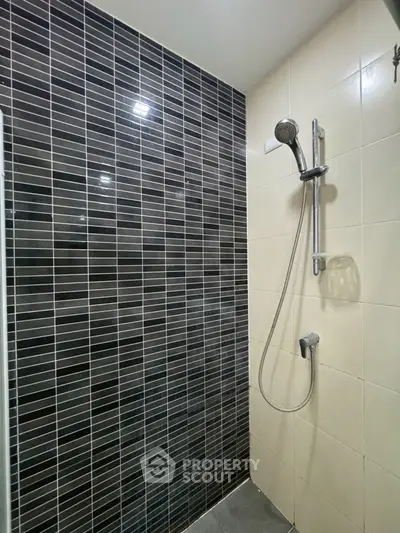 Modern bathroom with sleek black and white tiled shower area