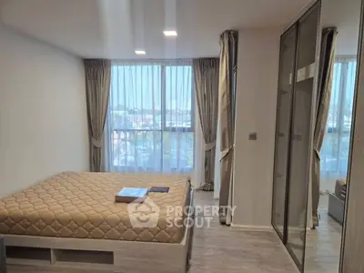 Modern bedroom with large window and stylish decor