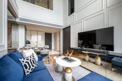 Luxurious modern living room with high ceilings and elegant decor in a stylish apartment.