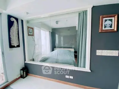 Modern bedroom with large glass window and stylish decor