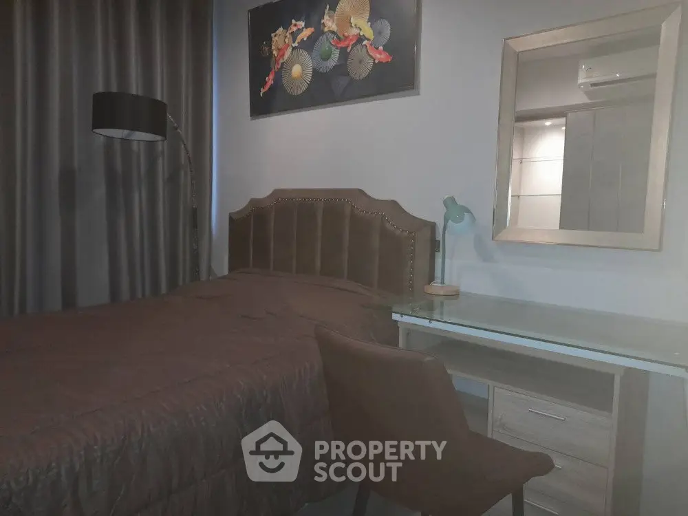 Cozy bedroom with modern decor, featuring a comfortable bed, stylish desk, and elegant lighting.