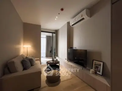 Modern living room with cozy sofa, stylish decor, and wall-mounted TV in a contemporary apartment.