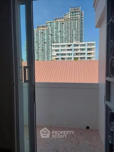 Charming balcony view with modern high-rise buildings in the background, perfect for urban living.
