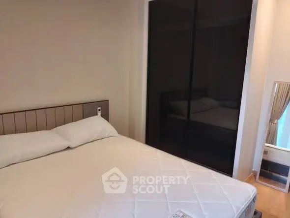 Cozy bedroom with modern design and large mirrored wardrobe