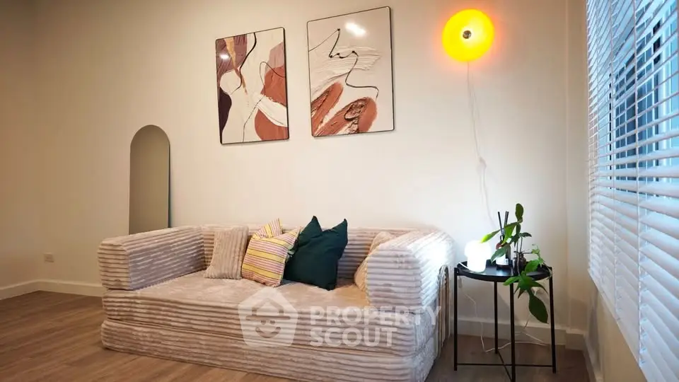 Stylish living room with modern art and cozy sofa