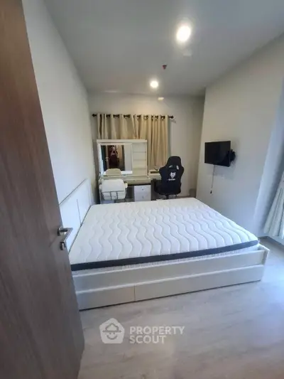 Modern bedroom with stylish furniture and natural light, perfect for a cozy living space.