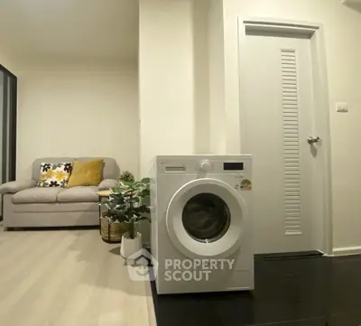 Modern apartment interior with washing machine and cozy living area