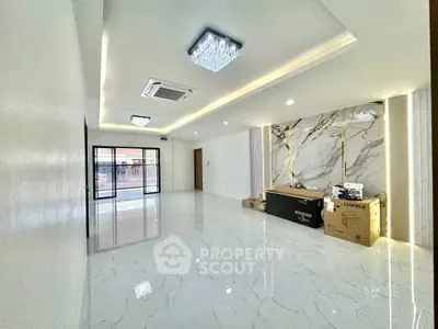 Spacious modern living room with marble flooring and elegant lighting