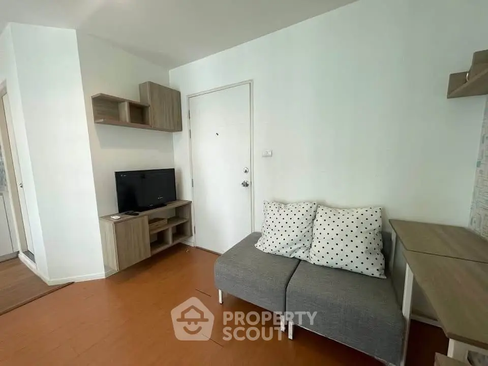 Cozy living room with modern furniture and wooden flooring in a stylish apartment.