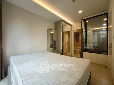 Modern bedroom with ensuite bathroom and large mirror closet