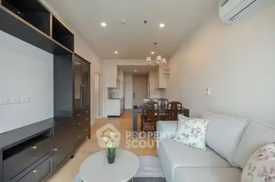Spacious modern living room with elegant furniture and open kitchen layout
