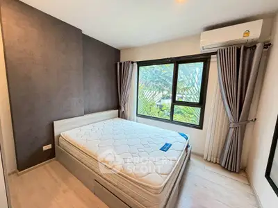 Modern bedroom with large window and air conditioning, featuring a comfortable bed and stylish decor.