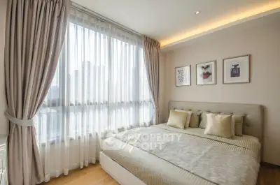 Bright and cozy bedroom with large window and elegant decor in modern apartment.