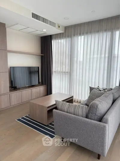 Modern living room with stylish furniture and large windows in a contemporary apartment.