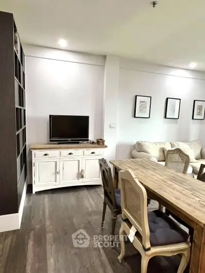 Charming living room with rustic dining set and cozy seating area, perfect for relaxation and entertainment.