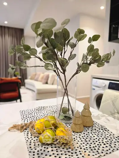 Modern living room with stylish decor and washing machine in open layout.