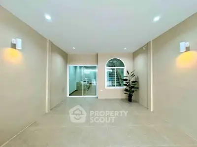 Spacious modern interior with neutral tones and elegant lighting, perfect for versatile living or office space.
