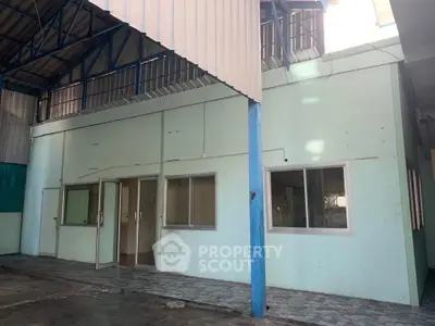 Spacious industrial warehouse with mezzanine level and ample natural light.