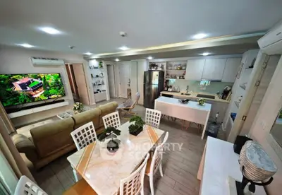 Spacious open-layout living room and kitchen with modern decor and ample natural light.