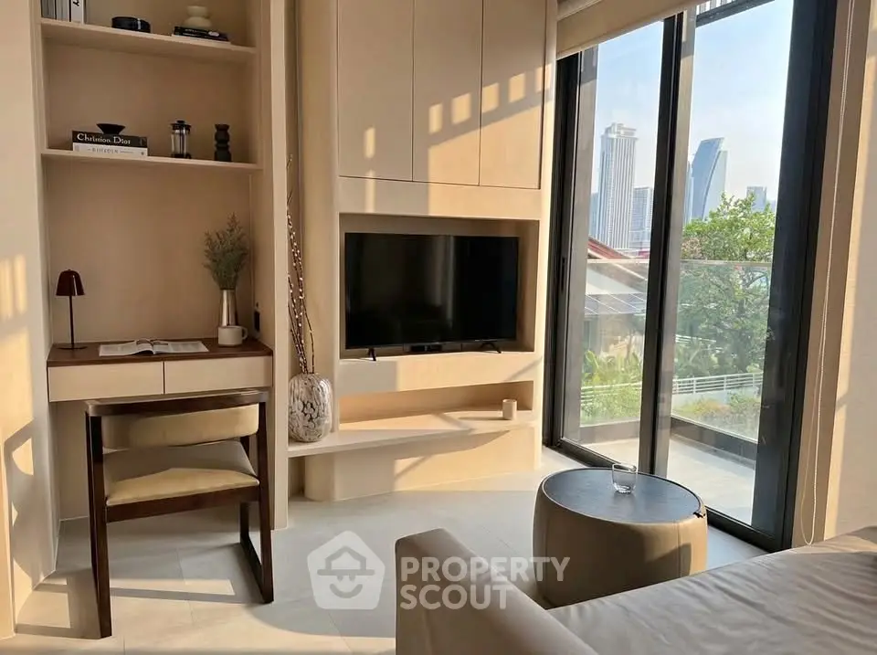 Modern living room with city view, featuring sleek furniture and large windows for natural light.