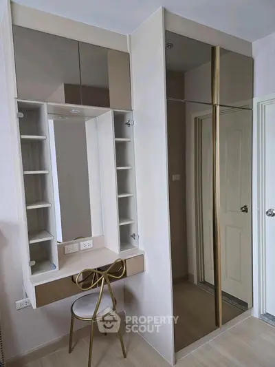 Modern bedroom with stylish vanity and mirrored wardrobe