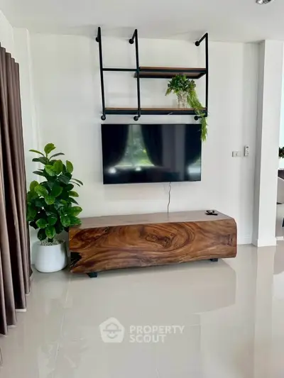 Modern living room with sleek TV setup and stylish wooden console