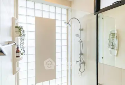 Modern bathroom with glass shower and natural light, perfect for a refreshing start to your day.