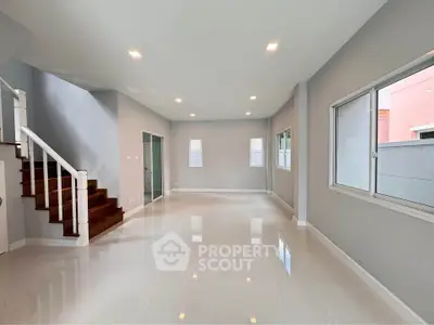Spacious modern living room with sleek design and ample natural light
