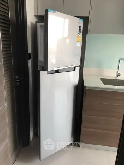 Modern kitchen with sleek fridge and stylish cabinetry