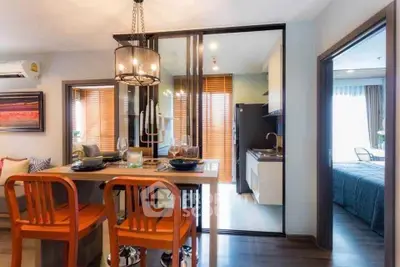 Modern open-plan dining and kitchen area with stylish decor and natural light.