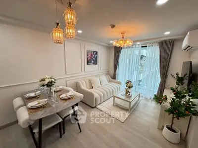 Elegant living room with modern decor and dining area, featuring stylish lighting and a cozy ambiance.