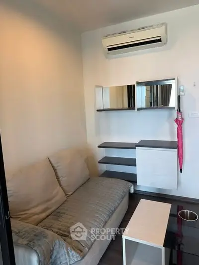 Cozy living room with modern air conditioning and stylish shelving, perfect for urban living.