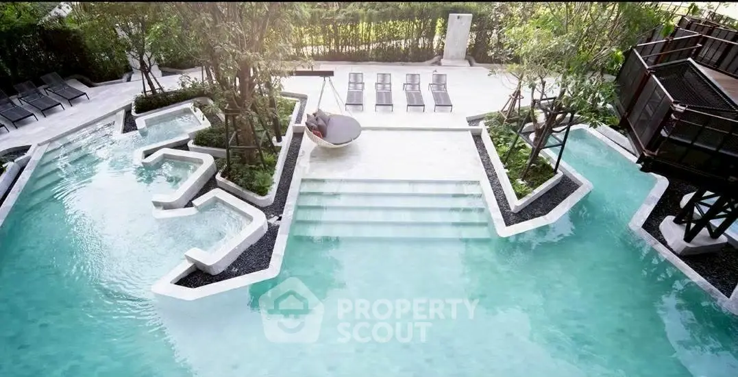 Luxurious outdoor pool area with modern design and lush greenery, perfect for relaxation and leisure.