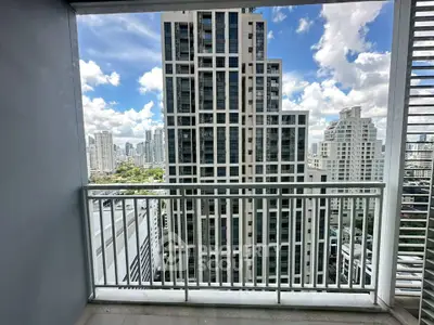 Stunning cityscape view from a modern balcony in a high-rise building.