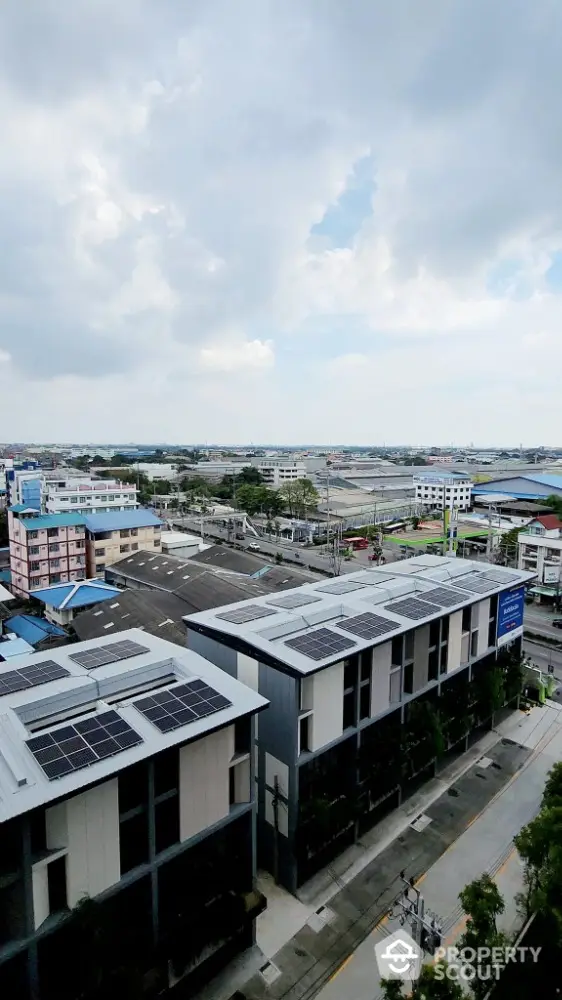 Modern urban building with solar panels and expansive city view