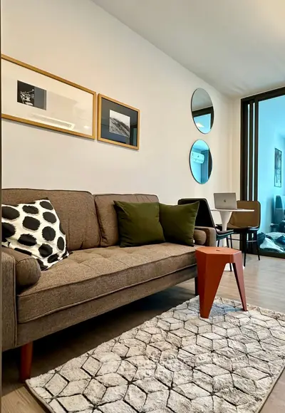 Stylish living room with modern decor, cozy sofa, and elegant wall art in a contemporary apartment.