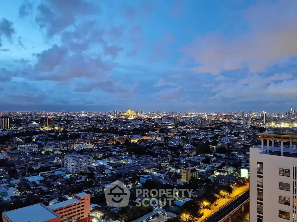 Stunning cityscape view from high-rise building at dusk, showcasing vibrant urban lights and expansive skyline.
