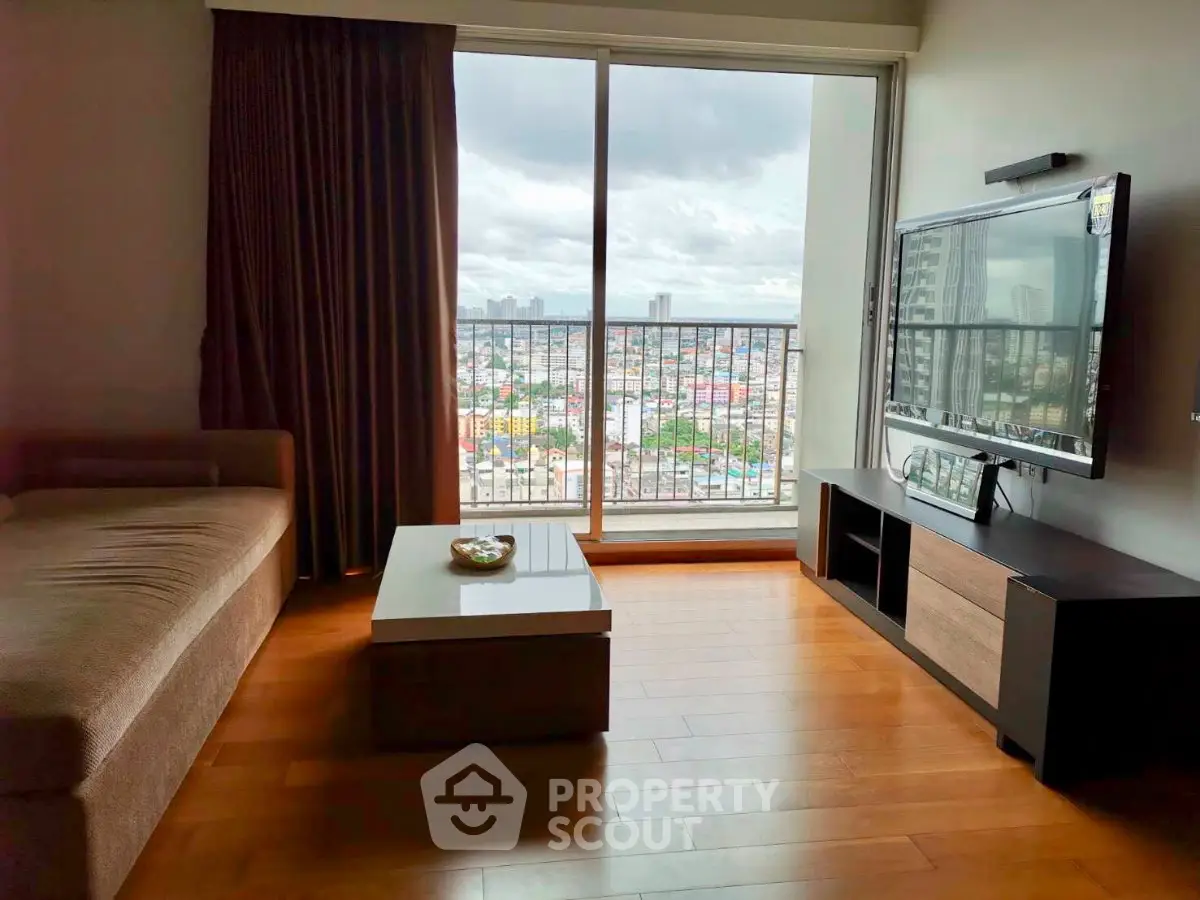 Modern living room with large window offering stunning city view, featuring sleek furniture and wooden flooring.