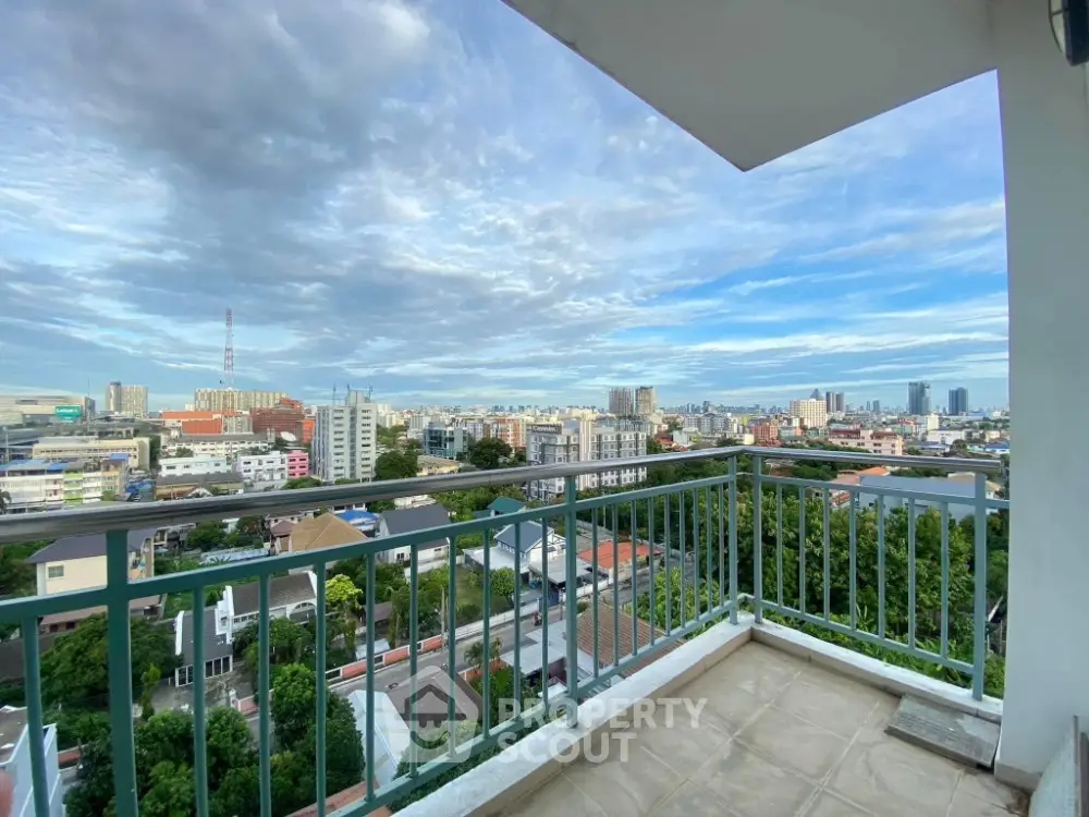 Stunning cityscape view from a spacious balcony in a high-rise apartment.