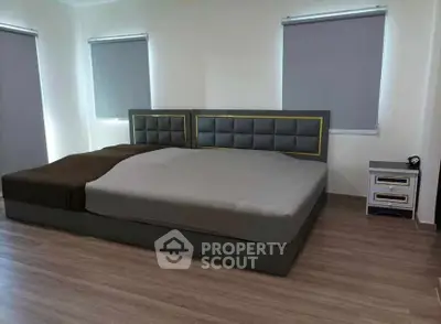 Spacious modern bedroom with stylish bed and sleek flooring