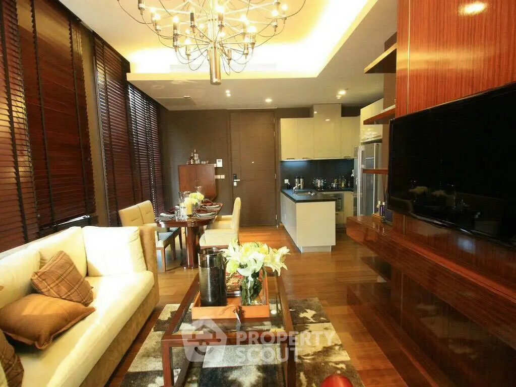 Luxurious modern living room with open kitchen, elegant decor, and ambient lighting.