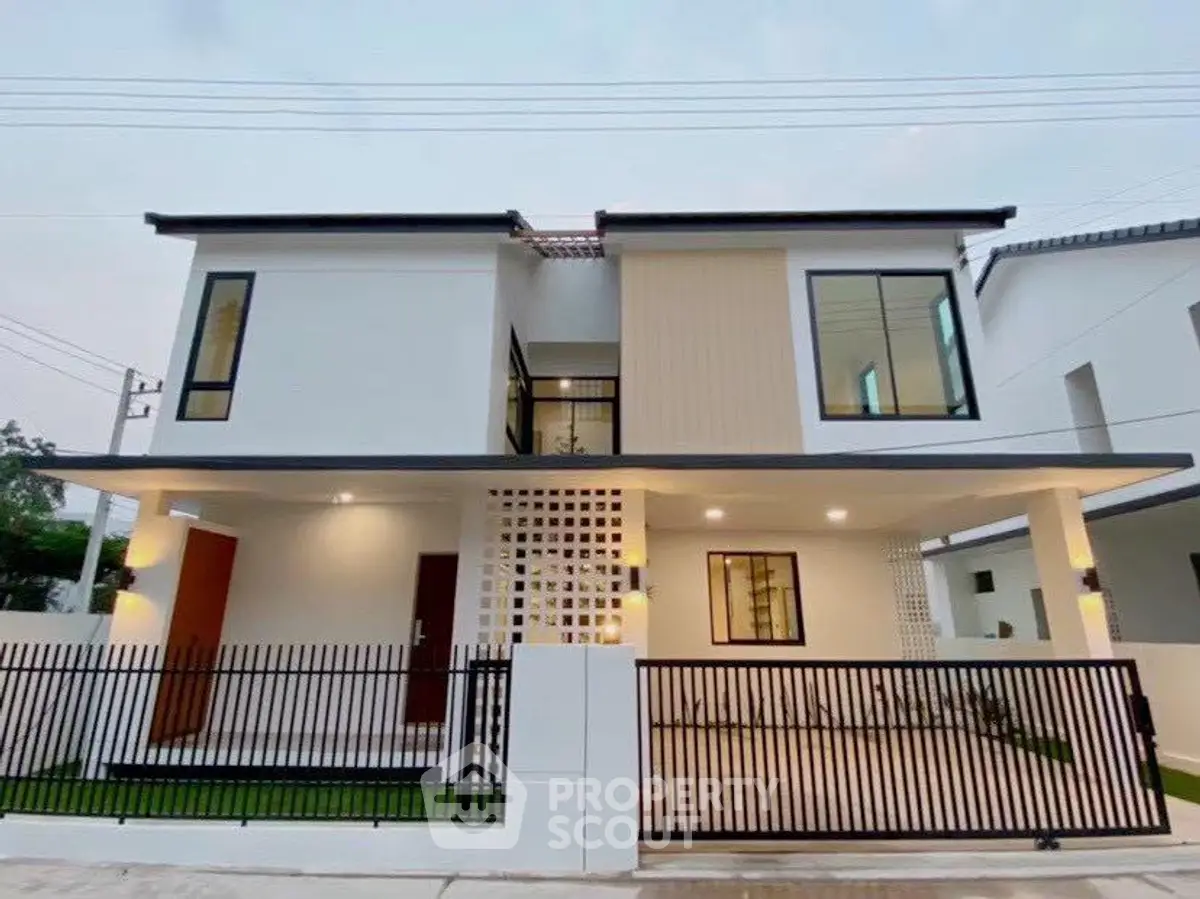 Modern two-story house with sleek design and spacious front yard