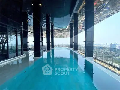 Luxurious rooftop pool with stunning city skyline views in modern high-rise building.