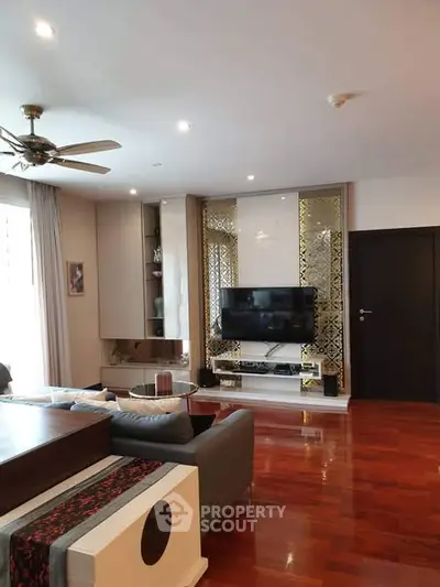 Spacious living room with modern decor and wooden flooring