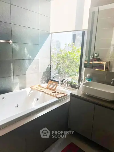 Luxurious bathroom with a large window offering a stunning city view, featuring a modern bathtub and sleek vanity.